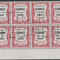 Guinea - Conakry 1987 Dove 2000f Revenue stamp in block of 8 showing complete perfin 'T.D.L.R. SPECIMEN' unmounted mint ex De La Rue archive sheet and rare thus
