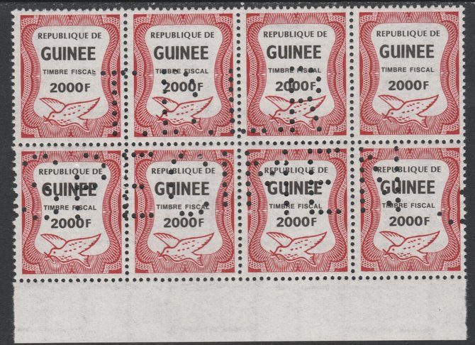 Guinea - Conakry 1987 Dove 2000f Revenue stamp in block of 8 showing complete perfin 'T.D.L.R. SPECIMEN' unmounted mint ex De La Rue archive sheet and rare thus